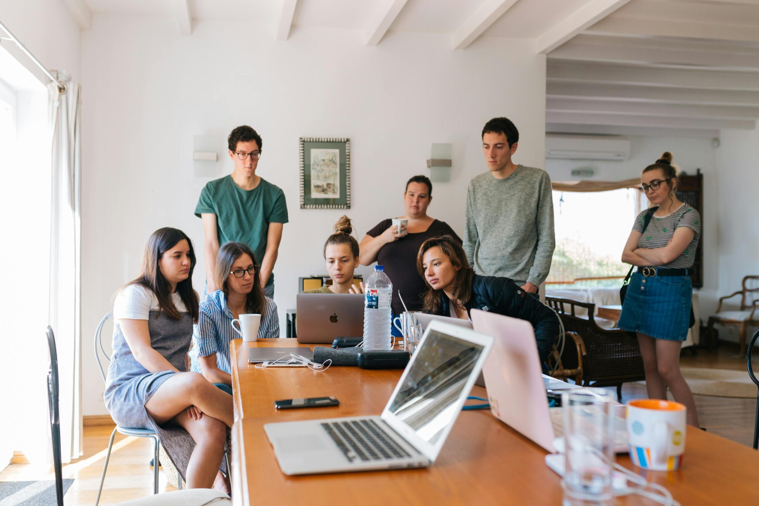 Group of young professionals engaged in a collaborative meeting in a modern office setting