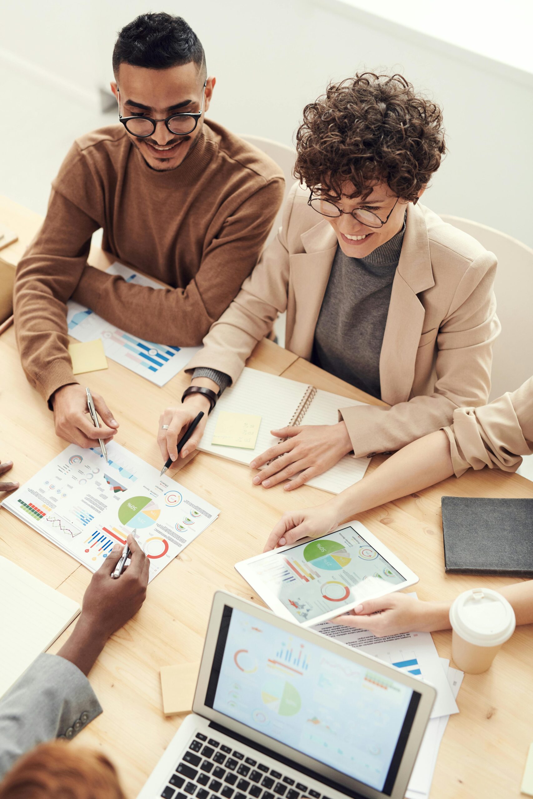 A diverse team of professionals collaborating over charts and graphs during a business meeting