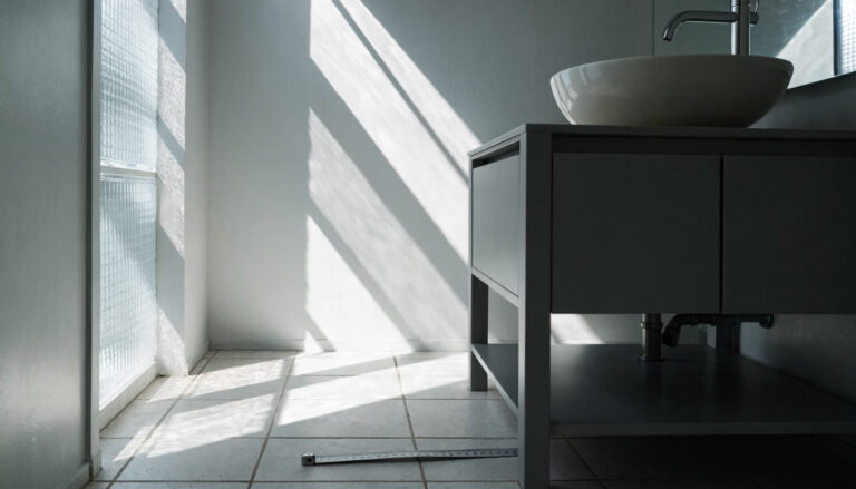 Bathroom vanity with a tape measure showing clearance